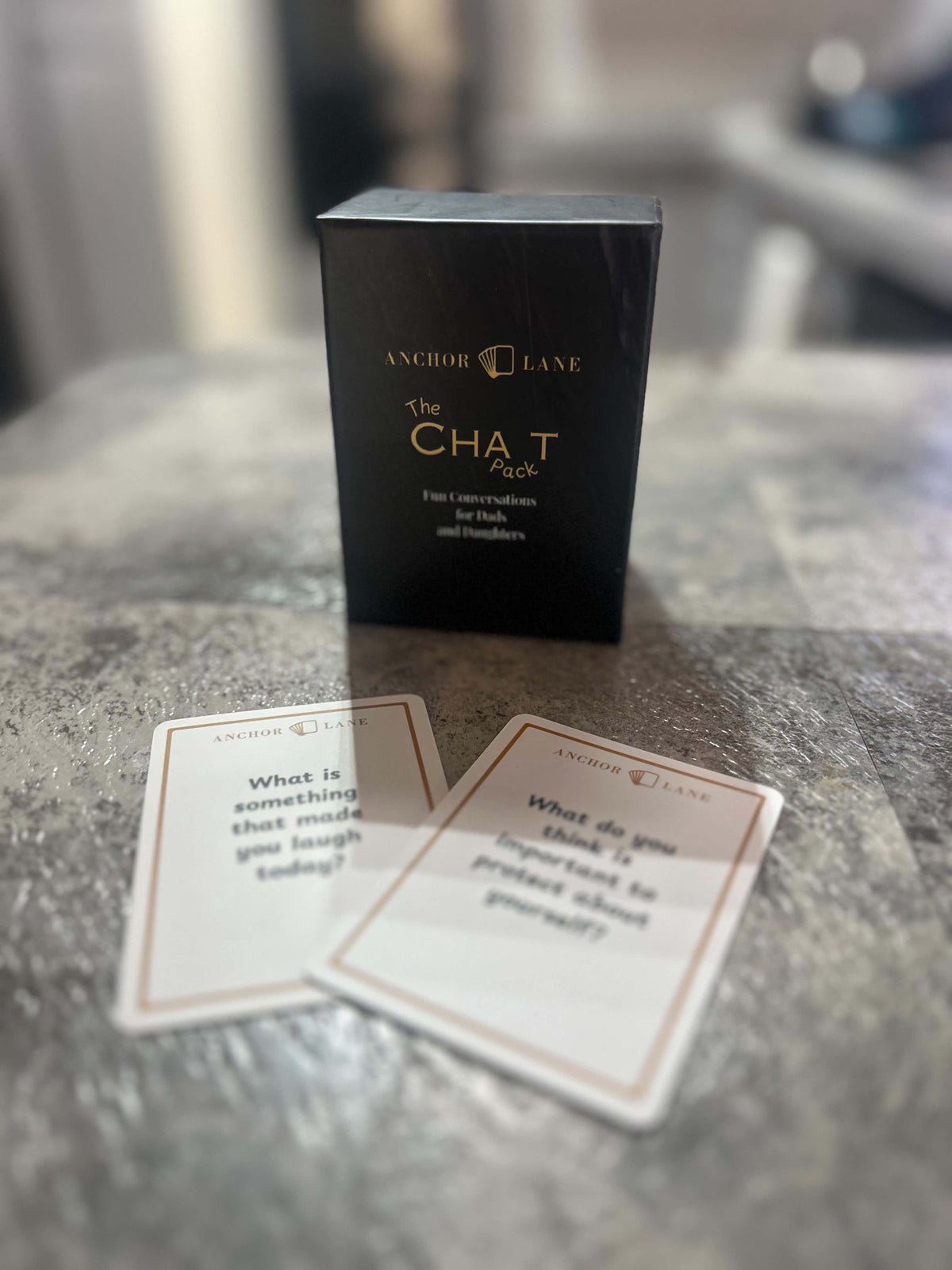 Anchor Lane Chat Pack box and two conversation cards on a kitchen bench